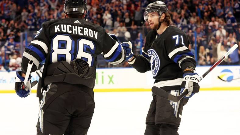 Feb 15, 2024; Tampa, Florida, USA; Tampa Bay Lightning right wing Nikita Kucherov (86) is Colorado Avalanche by Tampa Bay Lightning center Anthony Cirelli (71) after he scored a goal against the Colorado Avalanche during the first period at Amalie Arena. Mandatory Credit: Kim Klement Neitzel-USA TODAY Sports