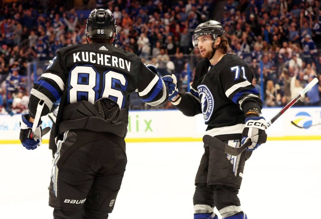 Feb 15, 2024; Tampa, Florida, USA; Tampa Bay Lightning right wing Nikita Kucherov (86) is Colorado Avalanche by Tampa Bay Lightning center Anthony Cirelli (71) after he scored a goal against the Colorado Avalanche during the first period at Amalie Arena. Mandatory Credit: Kim Klement Neitzel-USA TODAY Sports