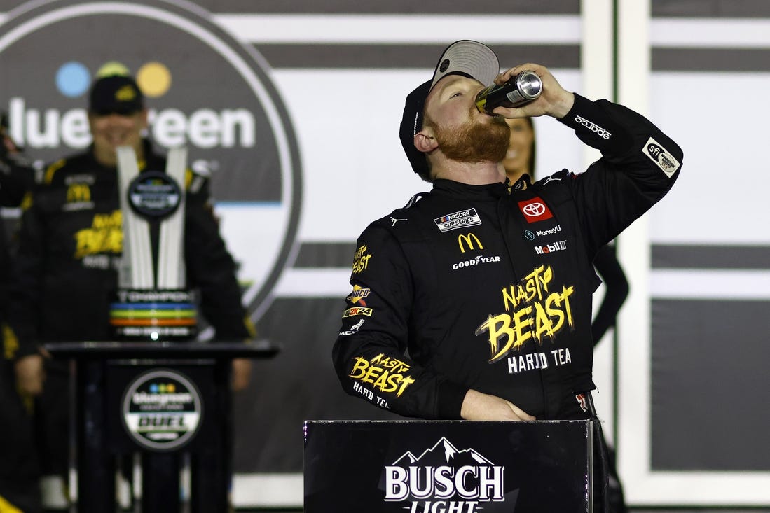 Feb 15, 2024; Daytona Beach, Florida, USA; NASCAR Cup Series driver Tyler Reddick (45) reacts in victory lane after winning the Bluegreen Vacations Duel 1 at Daytona International Speedway. Mandatory Credit: Peter Casey-USA TODAY Sports