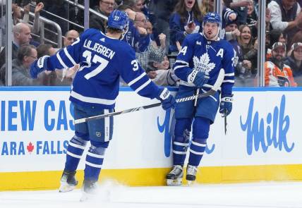 Feb 15, 2024; Toronto, Ontario, CAN; Toronto Maple Leafs center Auston Matthews (34) scores his first goal and celebrates with defenseman Timothy Liljegren (37) against the Philadelphia Flyers during the second period at Scotiabank Arena. Mandatory Credit: Nick Turchiaro-USA TODAY Sports