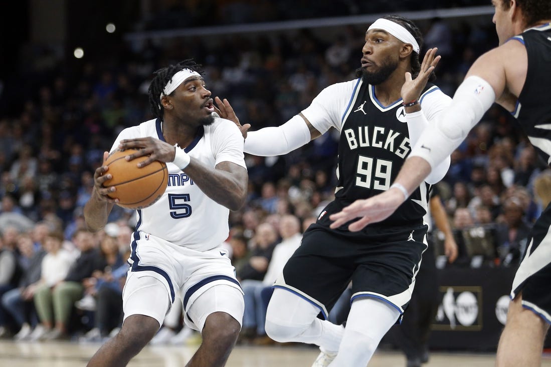 Feb 15, 2024; Memphis, Tennessee, USA; Memphis Grizzlies guard Vince Williams Jr. (5) handles the ball as Milwaukee Bucks forward Jae Crowder (99) defends during the first half at FedExForum. Mandatory Credit: Petre Thomas-USA TODAY Sports