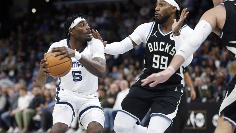 Feb 15, 2024; Memphis, Tennessee, USA; Memphis Grizzlies guard Vince Williams Jr. (5) handles the ball as Milwaukee Bucks forward Jae Crowder (99) defends during the first half at FedExForum. Mandatory Credit: Petre Thomas-USA TODAY Sports