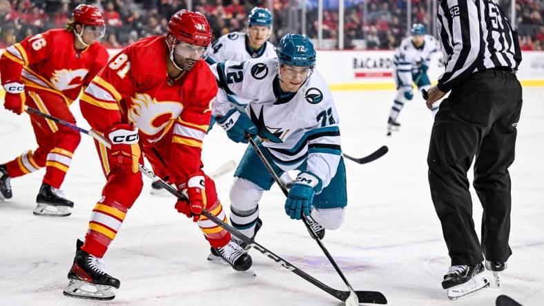 Feb 15, 2024; Calgary, Alberta, CAN; Calgary Flames center Nazem Kadri (91) and San Jose Sharks left wing William Eklund (72) take a face-off during the first period at Scotiabank Saddledome. Mandatory Credit: Brett Holmes-USA TODAY Sports