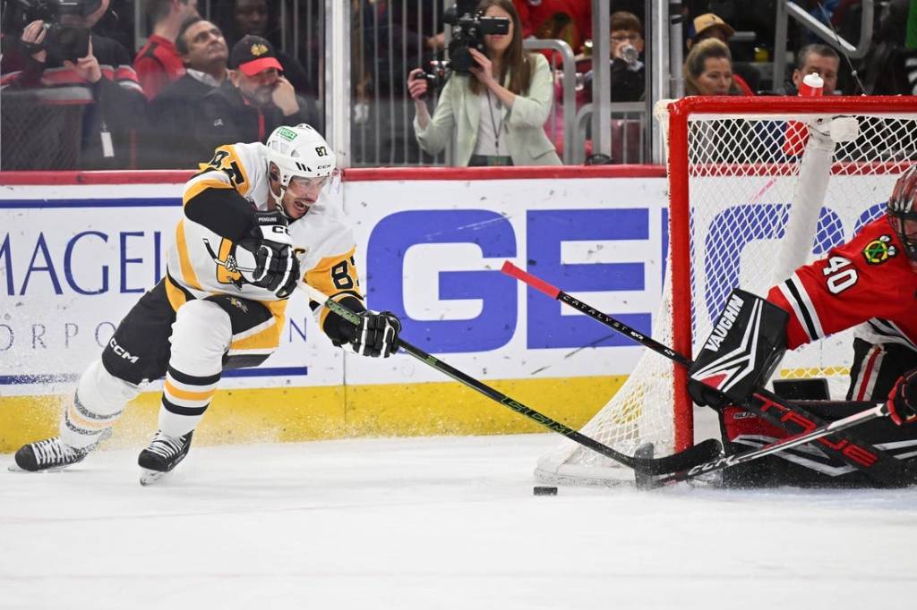 Feb 15, 2024; Chicago, Illinois, USA; Pittsburgh Penguins forward Sidney Crosby (87) attempts a shot on Chicago Blackhawks goaltender Arvid Soderblom (40) in the second period at United Center. Mandatory Credit: Jamie Sabau-USA TODAY Sports