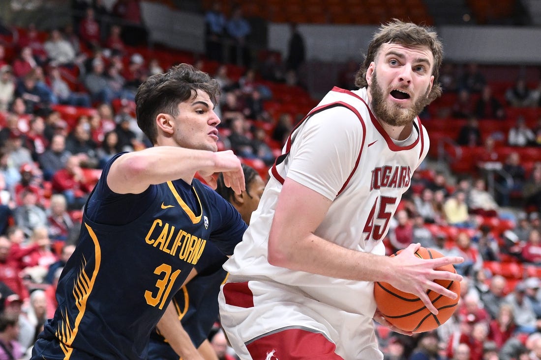 Feb 15, 2024; Pullman, Washington, USA; Washington State Cougars forward Oscar Cluff (45) shoots the ball against California Golden Bears guard Gus Larson (31) in the first half at Friel Court at Beasley Coliseum. Mandatory Credit: James Snook-USA TODAY Sports