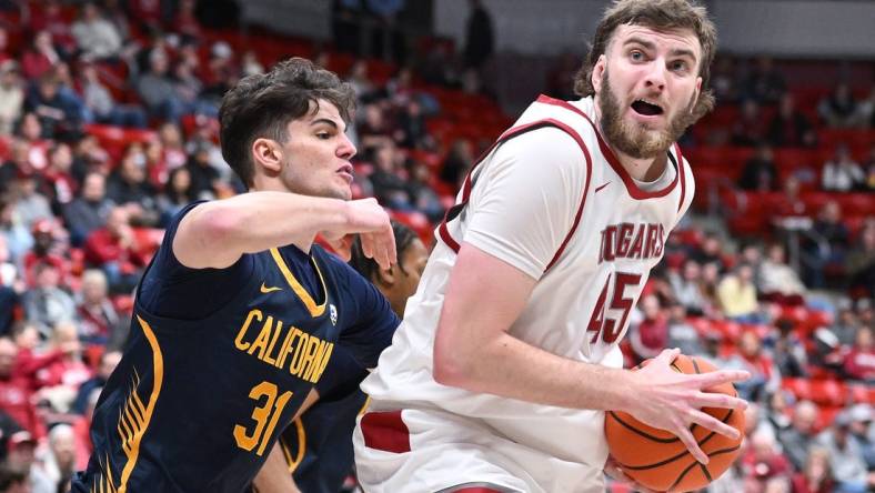 Feb 15, 2024; Pullman, Washington, USA; Washington State Cougars forward Oscar Cluff (45) shoots the ball against California Golden Bears guard Gus Larson (31) in the first half at Friel Court at Beasley Coliseum. Mandatory Credit: James Snook-USA TODAY Sports