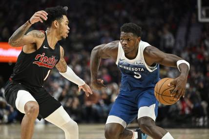 Feb 15, 2024; Portland, Oregon, USA; Minnesota Timberwolves guard Anthony Edwards (5) drives to the basket during the first half against Portland Trail Blazers guard Anfernee Simons (1) at Moda Center. Mandatory Credit: Troy Wayrynen-USA TODAY Sports