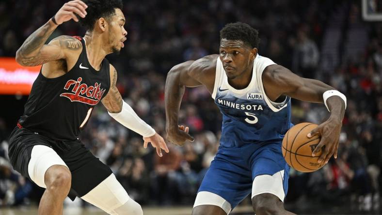 Feb 15, 2024; Portland, Oregon, USA; Minnesota Timberwolves guard Anthony Edwards (5) drives to the basket during the first half against Portland Trail Blazers guard Anfernee Simons (1) at Moda Center. Mandatory Credit: Troy Wayrynen-USA TODAY Sports