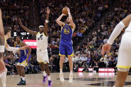 Feb 15, 2024; Salt Lake City, Utah, USA; Golden State Warriors guard Klay Thompson (11) shoots as Utah Jazz forward Taylor Hendricks (0) defends during the second half at Delta Center. Mandatory Credit: Chris Nicoll-USA TODAY Sports