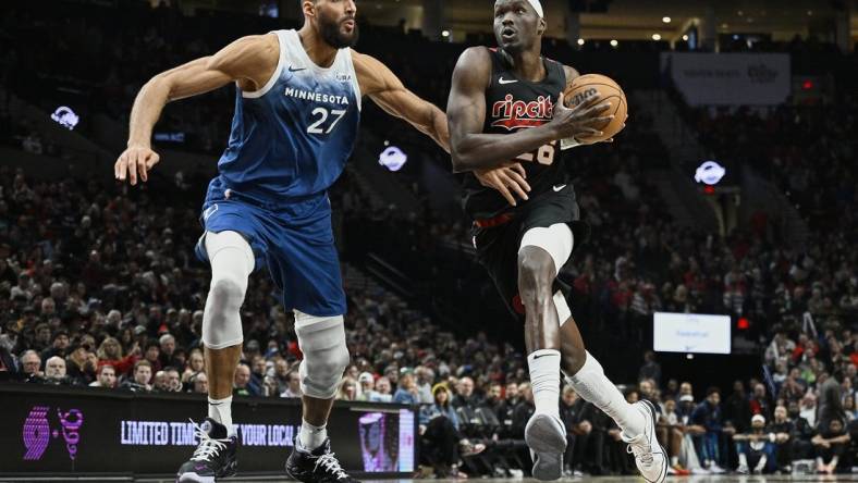 Feb 15, 2024; Portland, Oregon, USA; Portland Trail Blazers center Duop Reath (26) drives to the basket during the second half against Minnesota Timberwolves center Rudy Gobert (27) at Moda Center. Mandatory Credit: Troy Wayrynen-USA TODAY Sports