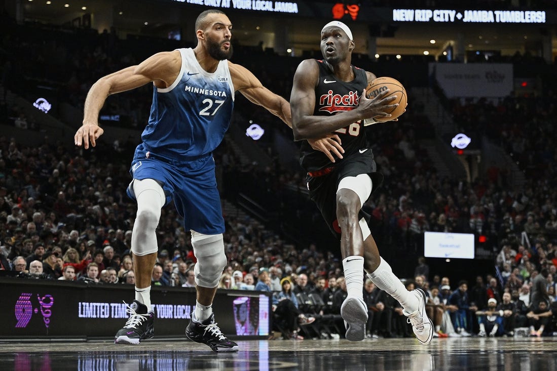 Feb 15, 2024; Portland, Oregon, USA; Portland Trail Blazers center Duop Reath (26) drives to the basket during the second half against Minnesota Timberwolves center Rudy Gobert (27) at Moda Center. Mandatory Credit: Troy Wayrynen-USA TODAY Sports