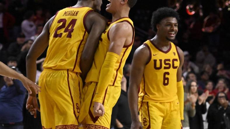 Feb 15, 2024; Los Angeles, California, USA; Southern California Trojans guard Kobe Johnson (center) celebrates with forward Joshua Morgan (24) and guard Bronny James (6) after the Trojans defeat the Utah Utes in a NCAA basketball game at Galen Center. Mandatory Credit: Alex Gallardo-USA TODAY Sports