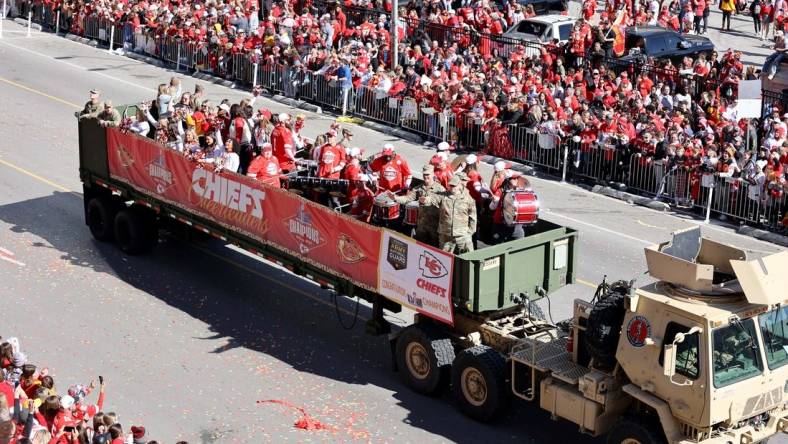 Feb 14, 2024; Kansas City, MO, USA; Fan watch the parade procession during the celebration of the Kansas City Chiefs winning Super Bowl LVIII. Mandatory Credit: Julia Kapros-USA TODAY Sports