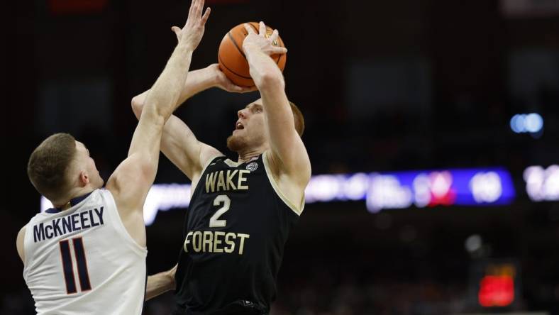 Feb 17, 2024; Charlottesville, Virginia, USA; Wake Forest Demon Deacons guard Cameron Hildreth (2) shoots the ball as Virginia Cavaliers guard Isaac McKneely (11) defends in the first half at John Paul Jones Arena. Mandatory Credit: Geoff Burke-USA TODAY Sports