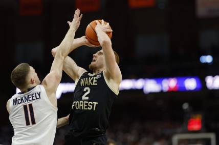 Feb 17, 2024; Charlottesville, Virginia, USA; Wake Forest Demon Deacons guard Cameron Hildreth (2) shoots the ball as Virginia Cavaliers guard Isaac McKneely (11) defends in the first half at John Paul Jones Arena. Mandatory Credit: Geoff Burke-USA TODAY Sports