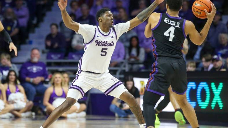 Feb 17, 2024; Manhattan, Kansas, USA; Kansas State Wildcats guard Cam Carter (5) guards TCU Horned Frogs guard Jameer Nelson Jr. (4) during the first half at Bramlage Coliseum. Mandatory Credit: Scott Sewell-USA TODAY Sports