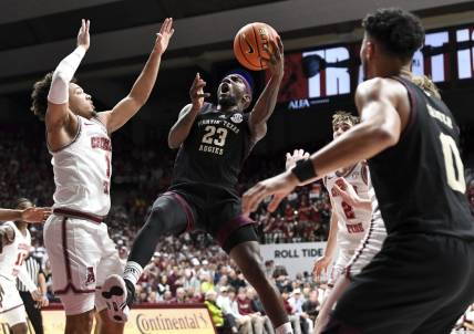 Feb 17, 2024; Tuscaloosa, Alabama, USA;  Texas A&M Aggies guard Tyrece Radford (23) shoots in the lane against Alabama Crimson Tide guard Mark Sears (1) during the first half at Coleman Coliseum. Mandatory Credit: Gary Cosby Jr.-USA TODAY Sports