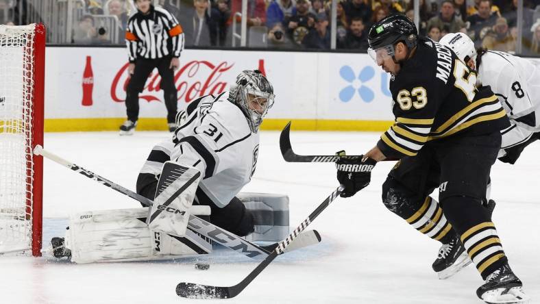 Feb 17, 2024; Boston, Massachusetts, USA; Boston Bruins left wing Brad Marchand (63) goes for a rebound in front of Los Angeles Kings goaltender David Rittich (31) during the first period at TD Garden. Mandatory Credit: Winslow Townson-USA TODAY Sports