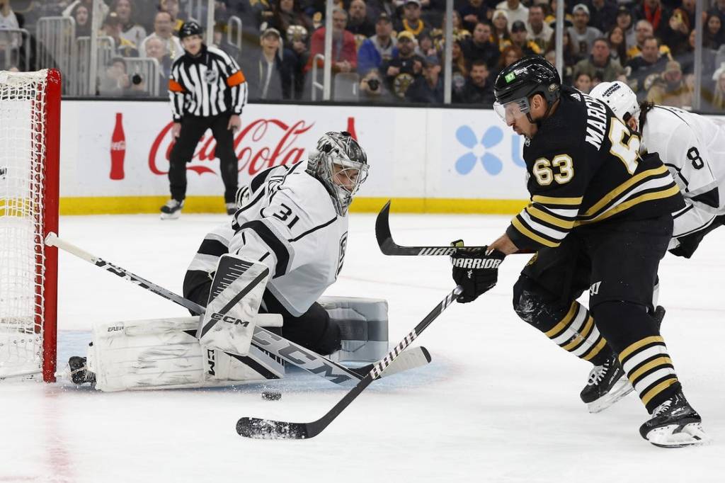 Feb 17, 2024; Boston, Massachusetts, USA; Boston Bruins left wing Brad Marchand (63) goes for a rebound in front of Los Angeles Kings goaltender David Rittich (31) during the first period at TD Garden. Mandatory Credit: Winslow Townson-USA TODAY Sports