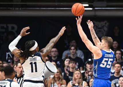 Feb 17, 2024; Indianapolis, Indiana, USA;  Creighton Bluejays guard Baylor Scheierman (55) attempts a shot over Butler Bulldogs guard Jahmyl Telfort (11) during the first half at Hinkle Fieldhouse. Mandatory Credit: Robert Goddin-USA TODAY Sports