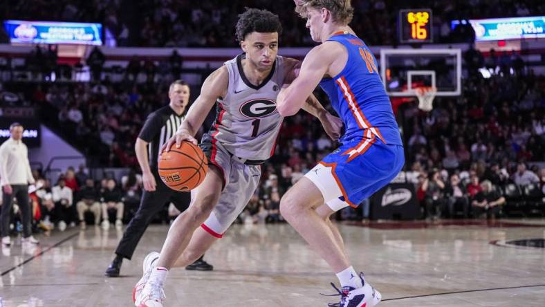 Feb 17, 2024; Athens, Georgia, USA; Georgia Bulldogs guard Jabri Abdur-Rahim (1) dribbles against Florida Gators forward Thomas Haugh (10) during the first half at Stegeman Coliseum. Mandatory Credit: Dale Zanine-USA TODAY Sports