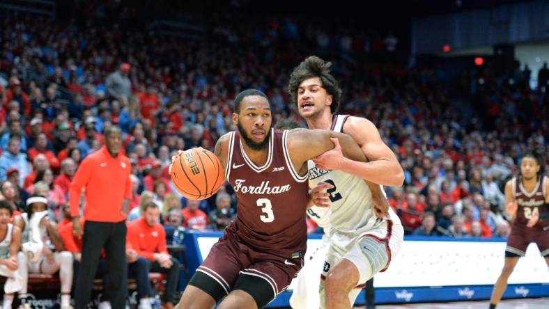 Feb 17, 2024; Dayton, Ohio, USA; Fordham Rams guard Jahmere Tripp (3) drives against Dayton Flyers forward Nate Santos (2) during a game at University of Dayton Arena. Mandatory Credit: Matt Lunsford-USA TODAY Sports