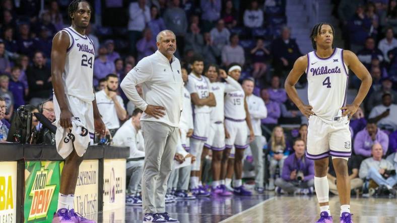 Feb 17, 2024; Manhattan, Kansas, USA; Kansas State Wildcats head coach Jerome Tang, forward Arthur Maluma (24) and guard Dai Dai Ames (4) watch as the TCU Horned Frogs shoots free throws during the second half at Bramlage Coliseum. Mandatory Credit: Scott Sewell-USA TODAY Sports