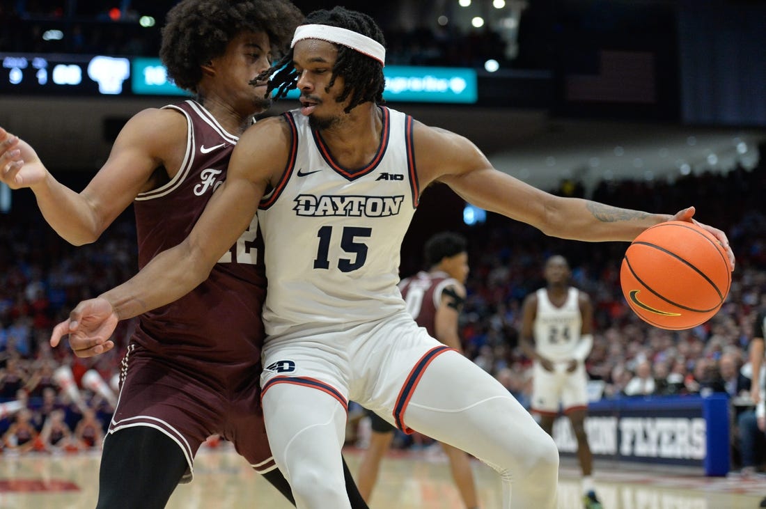 Feb 17, 2024; Dayton, Ohio, USA;  Dayton Flyers forward DaRon Holmes II (15) is fouled by Fordham Rams forward Elijah Gray (12) during a game at University of Dayton Arena. Mandatory Credit: Matt Lunsford-USA TODAY Sports