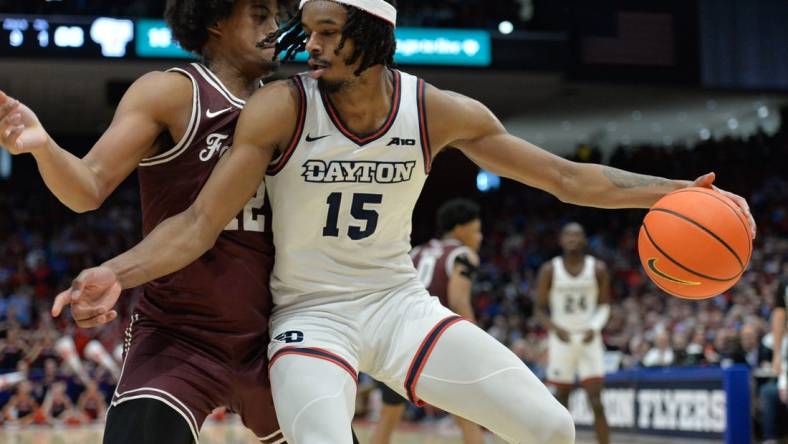 Feb 17, 2024; Dayton, Ohio, USA;  Dayton Flyers forward DaRon Holmes II (15) is fouled by Fordham Rams forward Elijah Gray (12) during a game at University of Dayton Arena. Mandatory Credit: Matt Lunsford-USA TODAY Sports