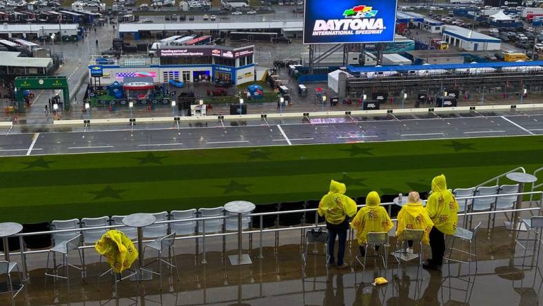 Race fans hope to wait out the rain delay at Daytona International Speedway, Saturday, Feb. 17, 2024.