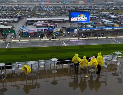 Race fans hope to wait out the rain delay at Daytona International Speedway, Saturday, Feb. 17, 2024.