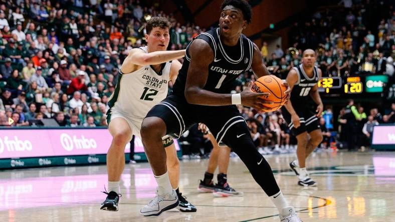 Feb 17, 2024; Fort Collins, Colorado, USA; Utah State Aggies forward Great Osobor (1) controls the ball against Colorado State Rams forward Patrick Cartier (12) in the first half at Moby Arena. Mandatory Credit: Isaiah J. Downing-USA TODAY Sports