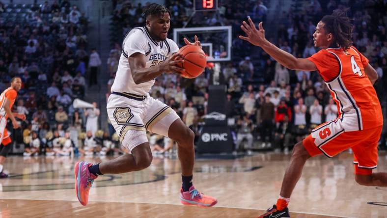 Feb 17, 2024; Atlanta, Georgia, USA; Georgia Tech Yellow Jackets forward Ibrahima Sacko (23) grabs the ball from Syracuse Orange forward Chris Bell (4) in the first half at McCamish Pavilion. Mandatory Credit: Brett Davis-USA TODAY Sports