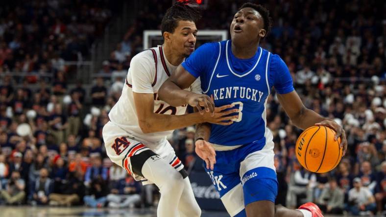 Kentucky Wildcats guard Adou Thiero (3) drives the ball on Auburn Tigers forward Chad Baker-Mazara (10) as Auburn Tigers take on Kentucky Wildcats at Neville Arena in Auburn, Ala., on Saturday, Feb. 17, 2024.