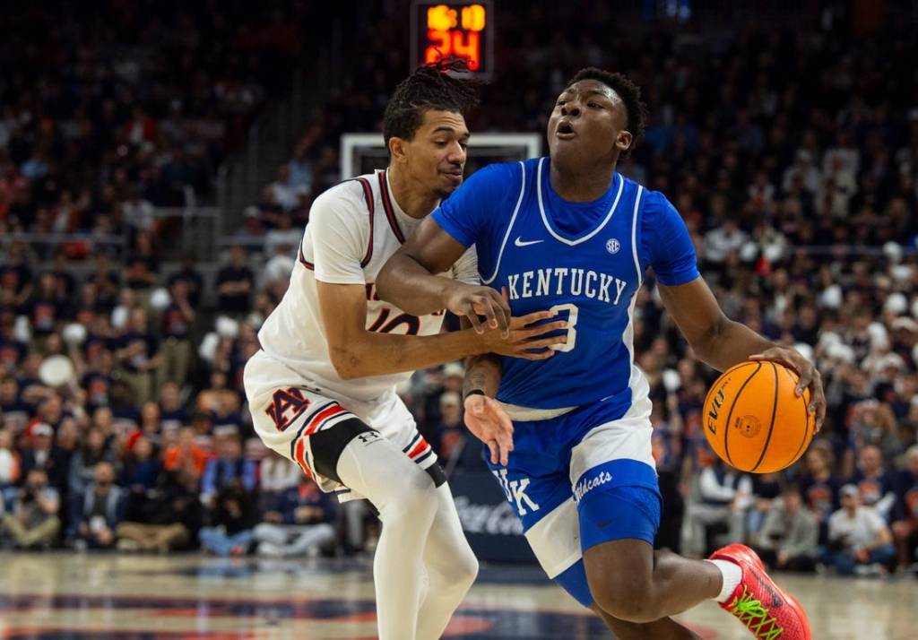 Kentucky Wildcats guard Adou Thiero (3) drives the ball on Auburn Tigers forward Chad Baker-Mazara (10) as Auburn Tigers take on Kentucky Wildcats at Neville Arena in Auburn, Ala., on Saturday, Feb. 17, 2024.