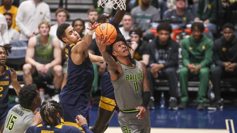 Feb 17, 2024; Morgantown, West Virginia, USA; Baylor Bears forward Jalen Bridges (11) shoots in the lane against West Virginia Mountaineers center Jesse Edwards (7) during the second half at WVU Coliseum. Mandatory Credit: Ben Queen-USA TODAY Sports