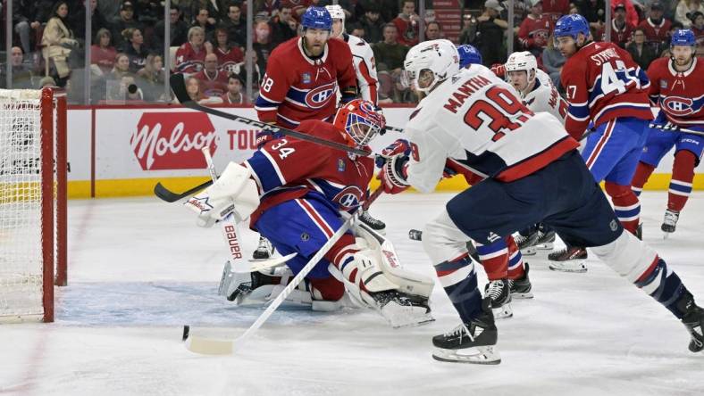 Feb 17, 2024; Montreal, Quebec, CAN; Washington Capitals forward Anthony Mantha (39) scores a goal against Montreal Canadiens goalie Jake Allen (34) during the first period at the Bell Centre. Mandatory Credit: Eric Bolte-USA TODAY Sports