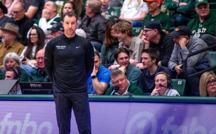 Utah State basketball head coach Danny Sprinkle stares off into the distance after a turnover in a blowout loss against Colorado State at Moby Arena on Saturday, Feb. 17, 2024 in Fort Collins, Colo.