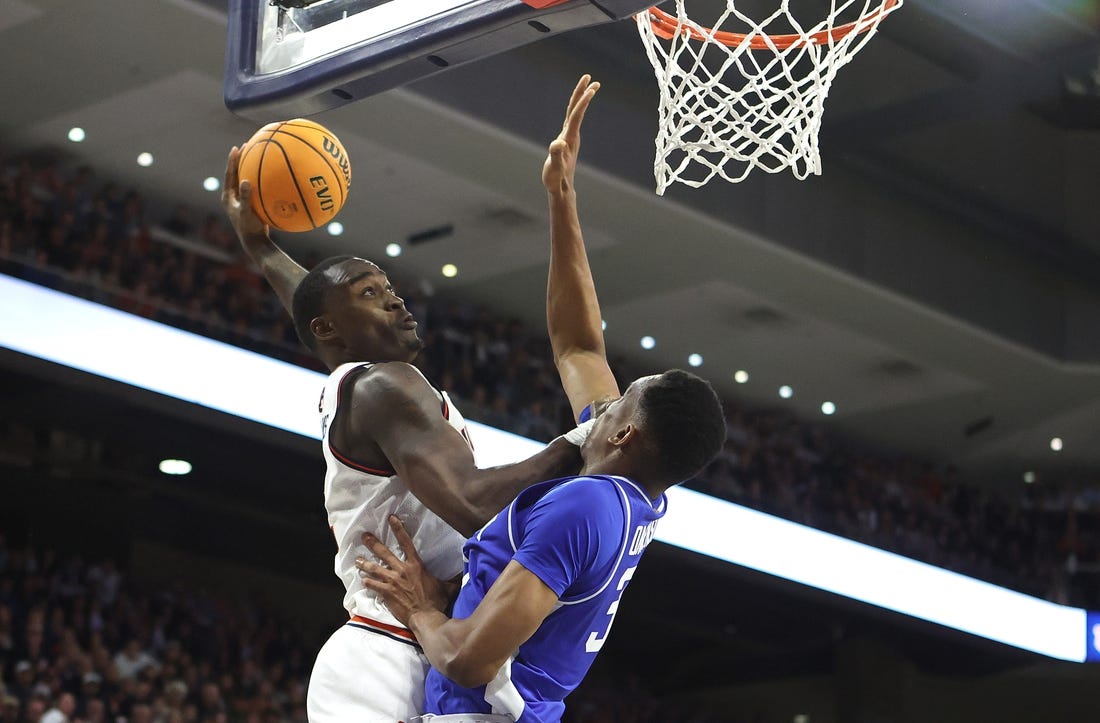 Feb 17, 2024; Auburn, Alabama, USA; Auburn Tigers forward Jaylin Williams (2) goes up against Kentucky Wildcats forward Ugonna Onyenso (33) for a shot during the second half at Neville Arena. Mandatory Credit: John Reed-USA TODAY Sports
