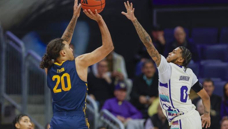 Feb 17, 2024; Seattle, Washington, USA; California Golden Bears guard Jaylon Tyson (20) makes a three-pointer against Washington Huskies guard Koren Johnson (0) during the first half at Alaska Airlines Arena at Hec Edmundson Pavilion. Mandatory Credit: Joe Nicholson-USA TODAY Sports