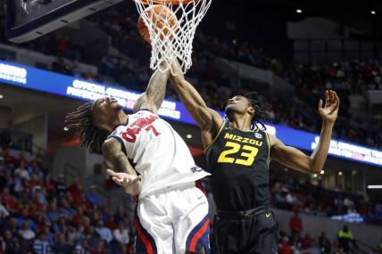 Feb 17, 2024; Oxford, Mississippi, USA; Mississippi Rebels guard Allen Flanigan (7) and Missouri Tigers forward Aidan Shaw (23) battle for a rebound during the first half at The Sandy and John Black Pavilion at Ole Miss. Mandatory Credit: Petre Thomas-USA TODAY Sports