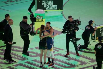 Feb 17, 2024; Indianapolis, IN, USA; Golden State Warriors guard Stephen Curry (30) competes in the Stephen vs. Sabrina 3-Point Challenge against New York Liberty guard Sabrina Ionescu (20) during NBA All Star Saturday Night at Lucas Oil Stadium. Mandatory Credit: Trevor Ruszkowski-USA TODAY Sports