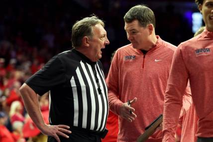 Feb 17, 2024; Tucson, Arizona, USA; Arizona Wildcats head coach Tommy Lloyd talks to the referee during a timeout against the Arizona State Sun Devils during the second half at McKale Center. Mandatory Credit: Zachary BonDurant-USA TODAY Sports