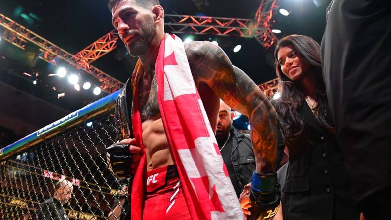 Feb 17, 2024; Anaheim, California, USA; Ilia Topuria celebrates his championship victory against Alexander Volkanovski during UFC 298 at Honda Center. Mandatory Credit: Gary A. Vasquez-USA TODAY Sports