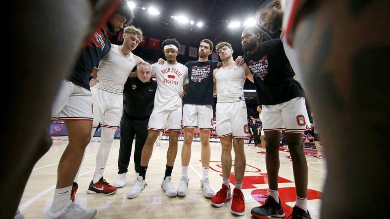 Feb 18, 2024; Columbus, Ohio, USA;  Ohio State Buckeyes guard Bowen Hardman (left) and guard Roddy Gayle Jr. (center) and forward Jamison Battle (center right) and guard Colby Baumann (42) huddle up before the game against the Purdue Boilermakers at Value City Arena. Mandatory Credit: Joseph Maiorana-USA TODAY Sports
