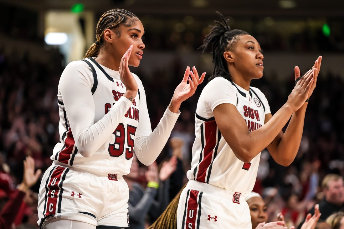 Feb 18, 2024; Columbia, South Carolina, USA; South Carolina Gamecocks center Sakima Walker (35) and forward Ashlyn Watkins (2) cheer from the bench against the Georgia Lady Bulldogs in the second half at Colonial Life Arena. Mandatory Credit: Jeff Blake-USA TODAY Sports