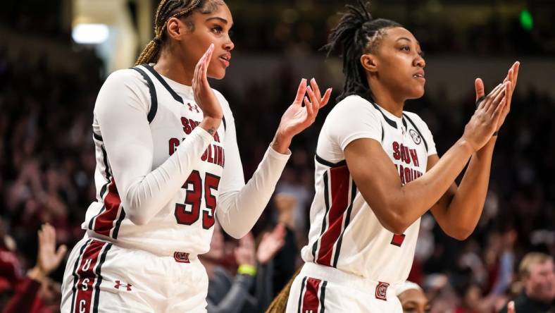 Feb 18, 2024; Columbia, South Carolina, USA; South Carolina Gamecocks center Sakima Walker (35) and forward Ashlyn Watkins (2) cheer from the bench against the Georgia Lady Bulldogs in the second half at Colonial Life Arena. Mandatory Credit: Jeff Blake-USA TODAY Sports