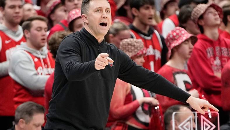 Feb 18, 2024; Columbus, Ohio, USA; Ohio State Buckeyes interim head coach Jake Diebler motions from the bench during the second half of the NCAA men   s basketball game against the Purdue Boilermakers at Value City Arena. Ohio State won 73-69.