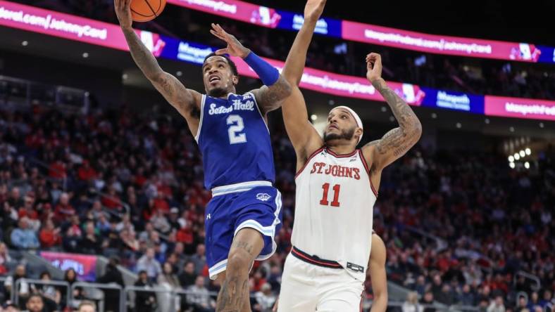 Feb 18, 2024; Elmont, New York, USA;  Seton Hall Pirates guard Al-Amir Dawes (2) drives past St. John's Red Storm center Joel Soriano (11) in the first half at UBS Arena. Mandatory Credit: Wendell Cruz-USA TODAY Sports