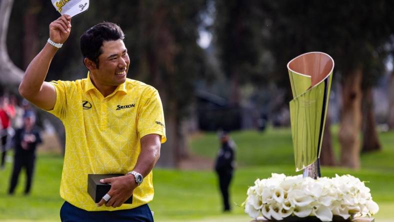 Feb 18, 2024; Pacific Palisades, California, USA; Hideki Matsuyama celebrates after winning The Genesis Invitational golf tournament at Riveria Country Club. Mandatory Credit: Jason Parkhurst-USA TODAY Sports